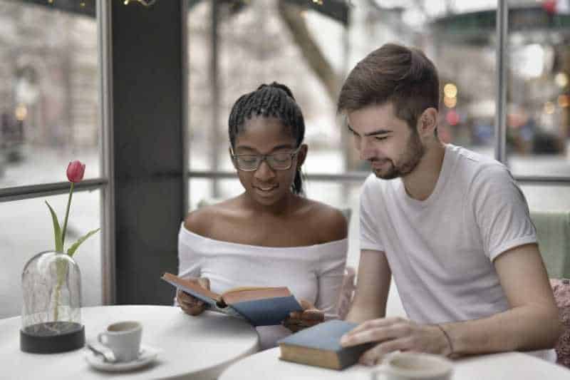 Couple reading books together.