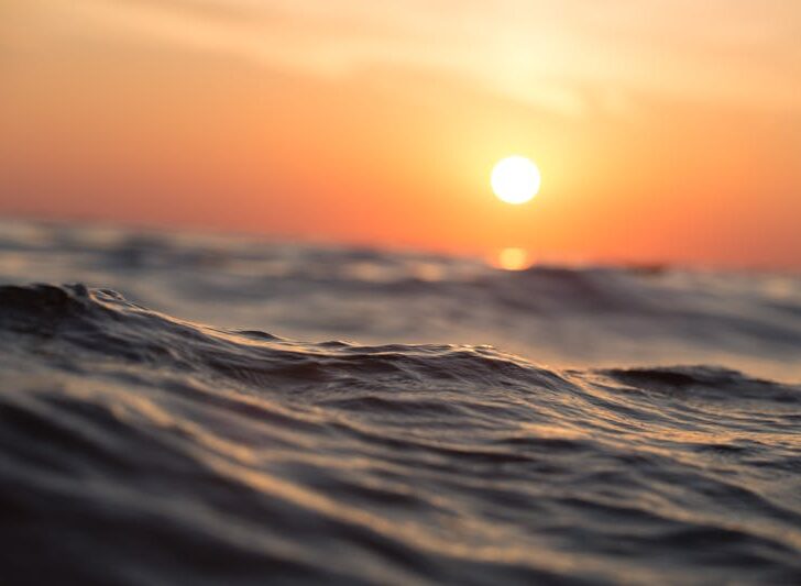 a close up of water and the sun