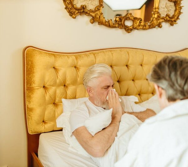 a man blowing his nose in a tissue