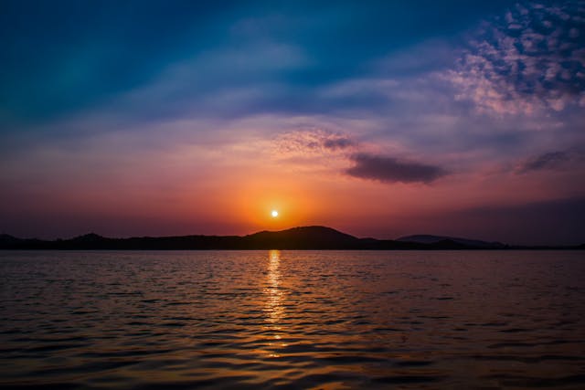 a sunset over a body of water