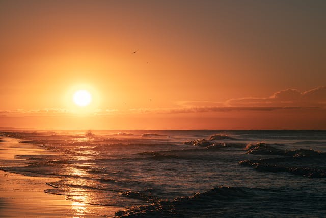 Sunset over calm ocean waves