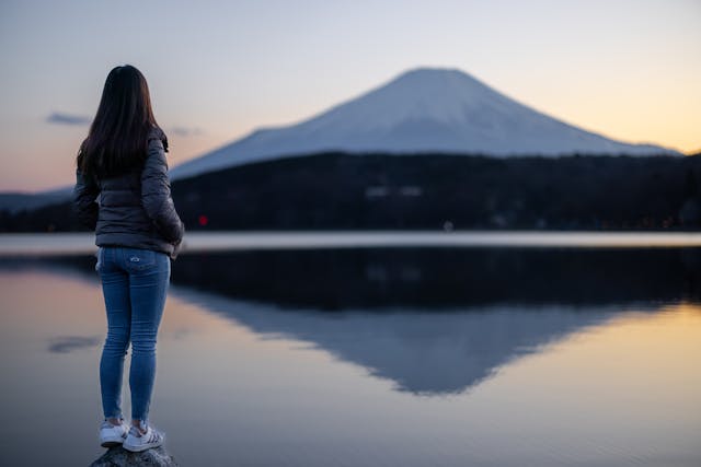Person gazing at Mount Fuji reflection
