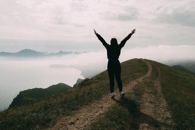 Person celebrating on mountain top