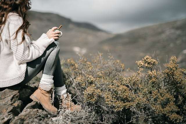 Woman sitting outdoors with coffee