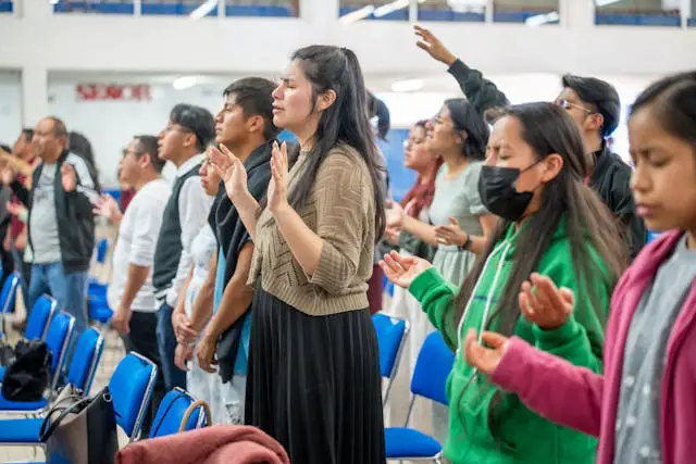 People engaged in a worship service.