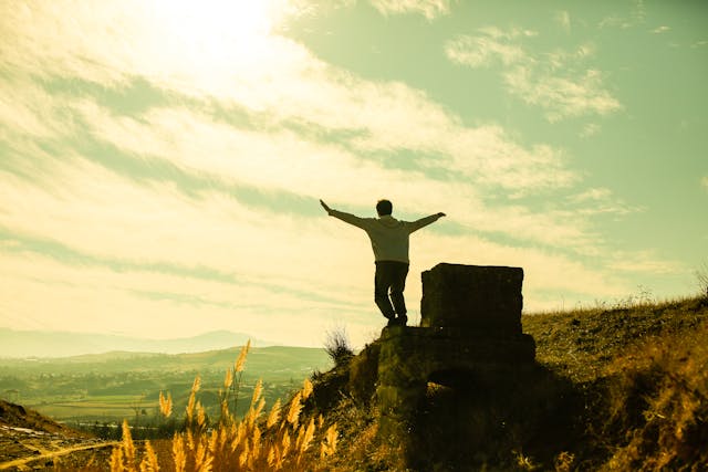 Person standing on a rocky ledge.