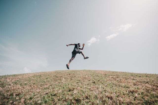 Person running on grassy hill