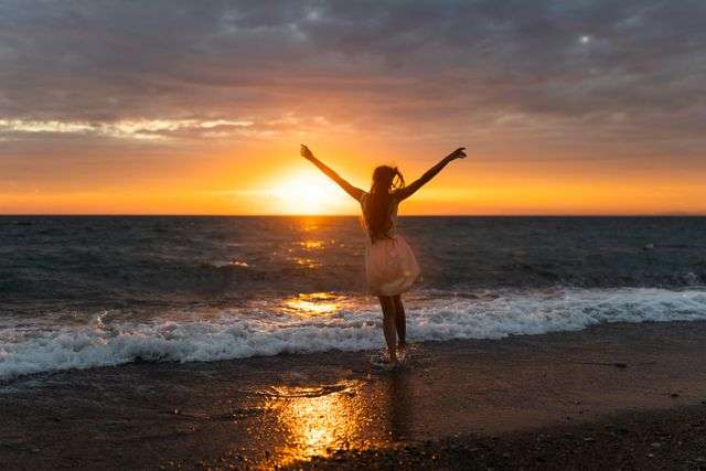 Girl enjoying sunset by the ocean