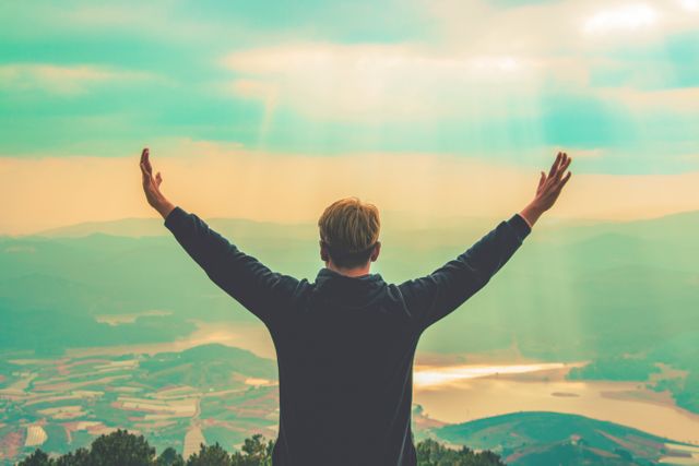 Person with arms raised, scenic view