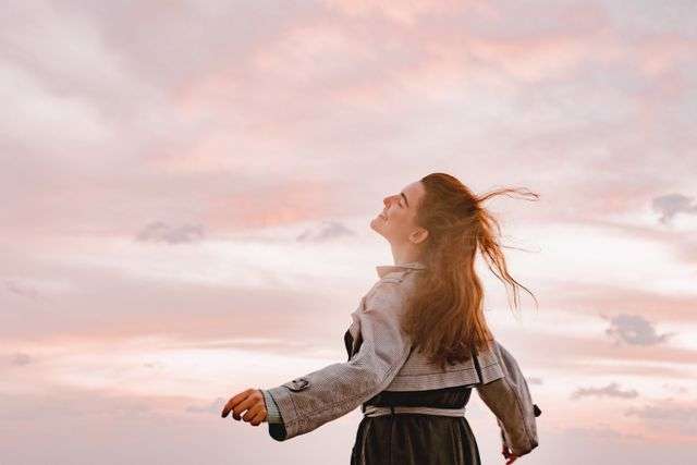Woman enjoying a sunset outdoors.